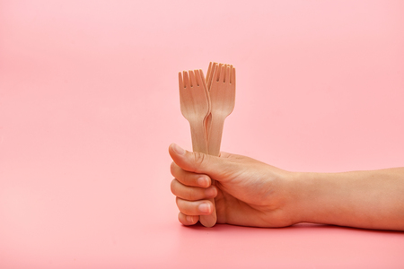 Disposable wooden cutlery forks in hand. The concept of environmental protection, zero wasteの写真素材