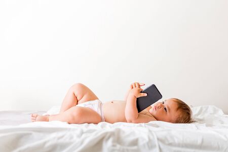 baby girl using mobile phone , browsing, copy space, gen z, watching carttons