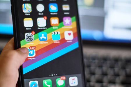 Poltava, Ukraine - August 1, 2019: HAnd iPhone 8 plus with social networking Telegram appのeditorial素材