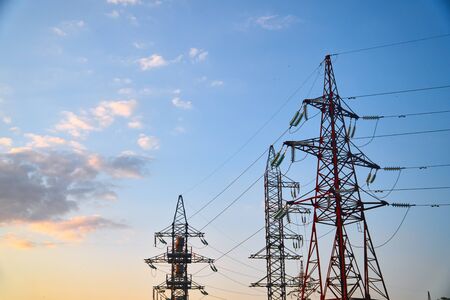 Pylon and transmission power line in sunset