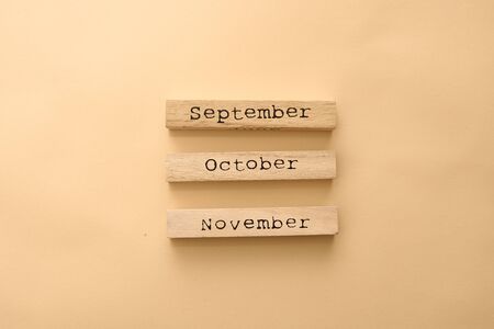 Wooden calendar autumn months on wooden cubes. Top view Flat Lay Minimalの写真素材