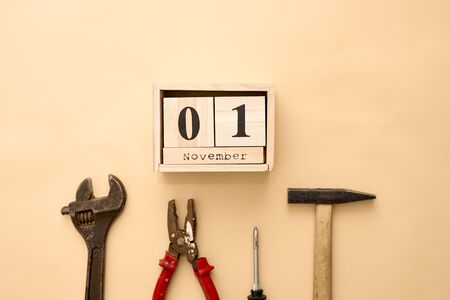 November 1st. Day 1 of November set on wooden calendar on on beige day. Tools setの写真素材