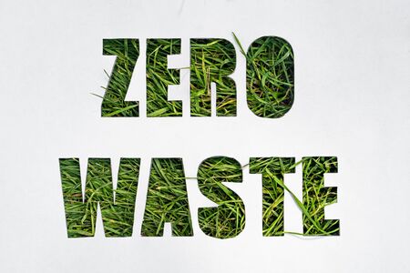 zero waste paper text with green grass on white backgroundの写真素材