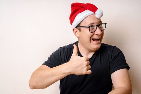 Happy Christmas Santa Claus showing thumb up. Isolated on white background. Lifestyle. Copy spaceの写真素材