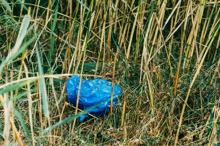 plastic bag in grass. Ecology problem. Summerの写真素材