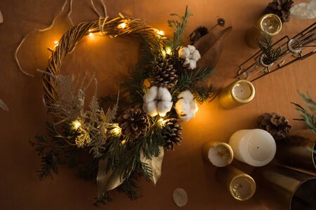 top view of florist hands making Christmas wreath with fir branches and led light. Top view, zero...