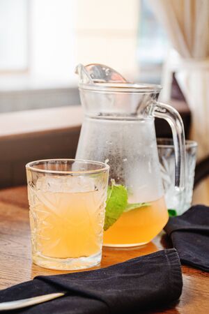 Orange juice lemonade in glass jar with mint leaf. Summer detox dit in restaurant. Outdoorsの写真素材