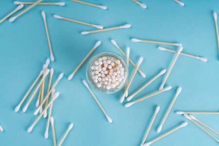 Cotton wooden ear swabs on blue background. Top view. Eco friendly, no plasticの写真素材