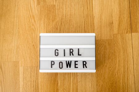 Girl power text on the lightbox. Top view. White background