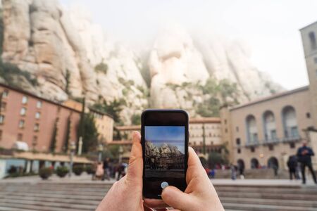 POV view of phone camera making photo of Montserrat Monastery in Spainの写真素材