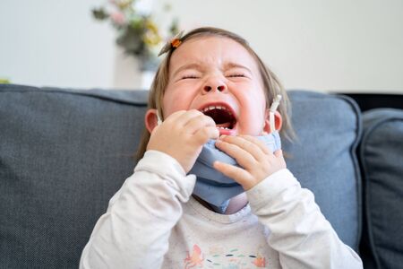 Toddler girl with medical mask on the face. Covid 2019 corona virus outbreak
