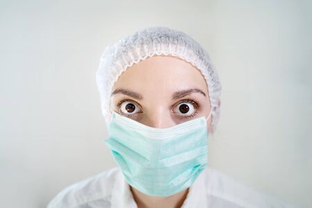 Shocked doctor with mask. Covid-19 coronavirus pandemic situationの写真素材