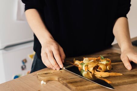 Millennial young woman recycling compost from kitchen waste. Circular economy, real food, organic wasteの写真素材