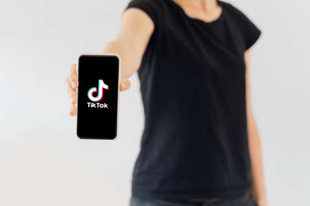 Poltava, Ukraine - May 2020 Tiktok app on phone screen in girl handsのeditorial素材