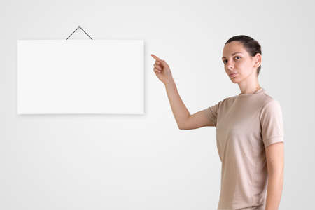 Caucasian woman with poster mock-up. Online e-learning. Back to school in quarantineの写真素材