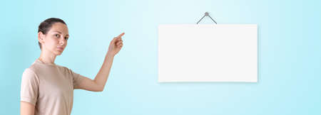 Caucasian woman with poster mock-up. Online e-learning. Back to school in quarantineの写真素材