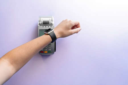 Top view of contactless payment with smart watch. Technology of paypass.