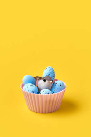 Muffin with easter blue eggs and bird. Springtime concept. Creative conceptual photoの写真素材
