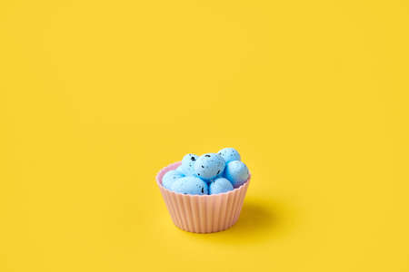 Muffin with easter blue eggs and bird. Springtime concept. Creative conceptual photoの写真素材