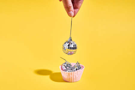 Muffin with disco balls and chef hand. Nightlife in retro style. 90s fashionの写真素材