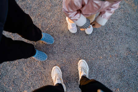 Top view of family legs on the ground outdoors. Bonding time together. Simple thingsの写真素材