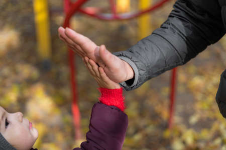Child and dad hands clap. Teamwork, connections, love relationship, care concept