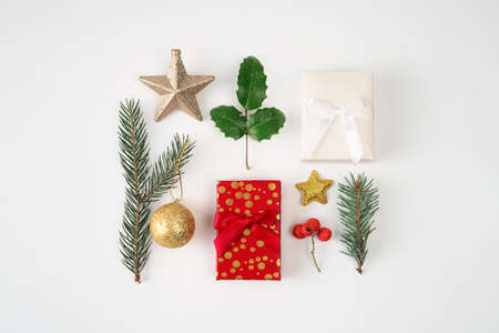 top view of Christmas decoration on white background. Pine fir, gift box, bauble, star.
