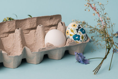 Painted chicken egg in floral pattern. DIY craft for easter holidays with kids. Botanical...