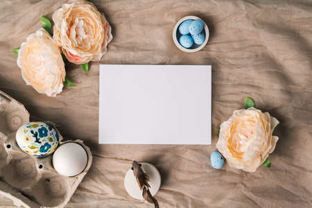 Mock up for easter congratulations or ads. White card template and easter eggs with acrylic paint...