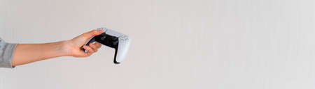 Videogame console wireless gamepad. white lifestyle background. Minimal style. Modern leisure at home. Web banner.の写真素材