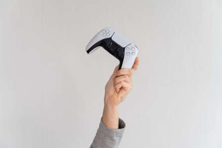 Videogame console wireless gamepad. white lifestyle background. Minimal style. Modern leisure at home.の写真素材