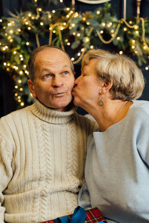 portrait of old couple wife and husband hugging and smiling. Dark blue background. Happy lovers on...