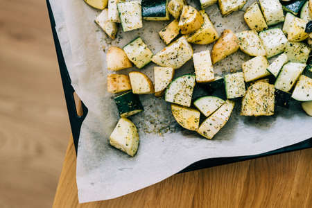 Healthy food background. Less meat concept. Vegetarian food on wooden background. Backing sheet with grilled seasoned vegetables. Lifestyle home cookingの写真素材
