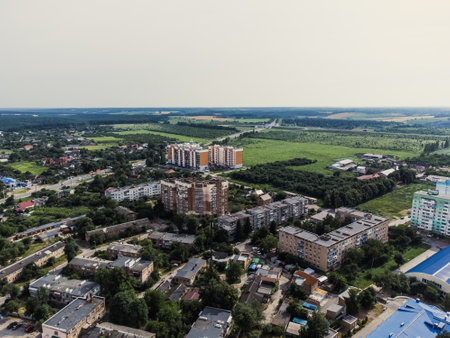Aerial view of suburb of European city. Green neighbourhood on a sunny summer day. County living. Drone point of viewの写真素材