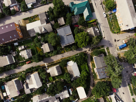 Aerial view of suburb of European city. Green neighbourhood on a sunny summer day. County living. Drone point of viewの写真素材