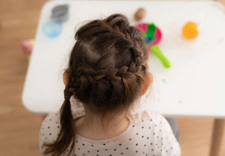 Girl child with hair messy braid at home, hairstyle for kids