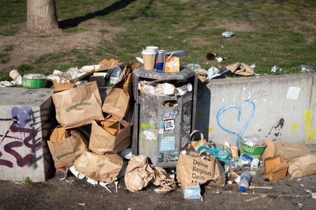 Berlin, Germany - 27 March 2022 Trash bin overloaded with garbage. City waste pollution problem.のeditorial素材