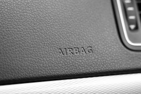 Close up of car interior panel with airbag sign on it. Leather texture and safety bags for car crashの写真素材