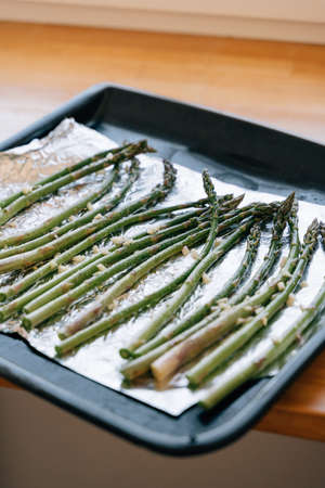 Green Asparagus sprouts on frying pen in kitchen. Grilled fresh vegetablesの写真素材