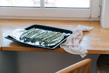 Green Asparagus sprouts on frying pen in kitchen. Grilled fresh vegetablesの写真素材