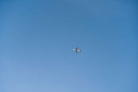 Plane in blue sky, minimal image of flight jetの写真素材