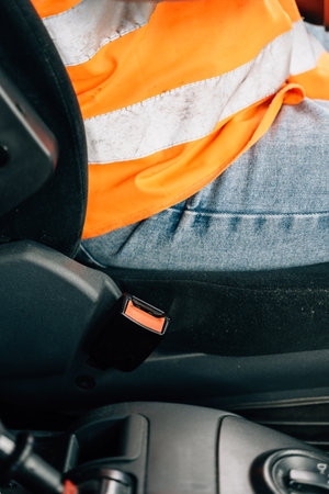 Close up of woman hand buckle the car safety belt. Truck driver occupation
