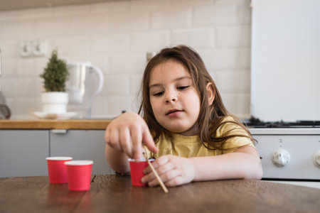 Small preschool child Lanting seed at home. Growing home or balcony gardenの写真素材