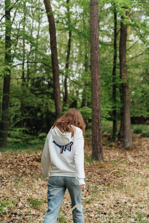 teenager gen z girl walking in the forest. close to nature concept