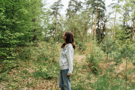 teenager gen z girl walking in the forest. close to nature conceptの写真素材
