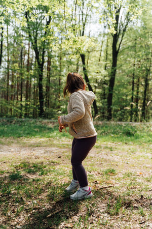 A child girl in the forest by hiking trail. Happy outdoorsy childhood. Getting fresh airの写真素材