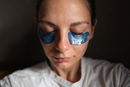 Young adult woman wearing eye patches in sun pocketの写真素材