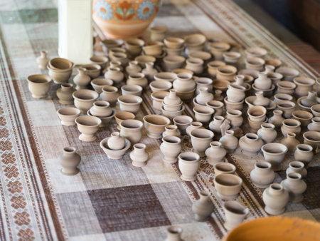 market or warehouse of ceramic small vessel on pottery wheel. Traditional cultural craft of house...