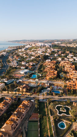 Coastal mediterranean town with villas and pools in scenic landscapeの写真素材