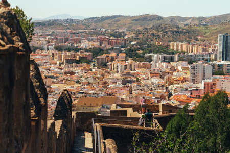 Scenic cityscape view from a historic stone rampart under a clear sky.の写真素材